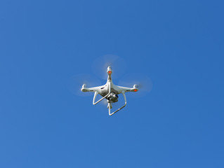 Drone in the air. Beautiful blue sky.