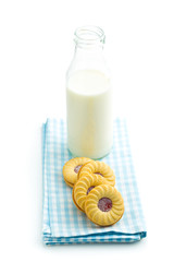 Jam ring biscuits and bottle of milk.