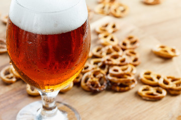 Beer glass pint with brezel. Traditional german Oktoberfest drink and food