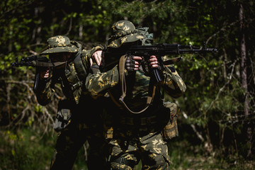 Fototapeta premium Military men with submachine gun