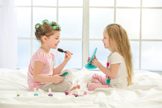 Little Kids Girls Sisters Doing Makeup Indoors