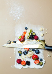 smeared cream with berries and knife