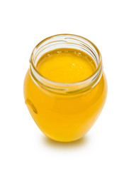 Sweet honey in glass jar on white background.