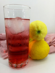 Glass with ice cream with soda next to some lemons