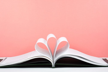 Old open hardback book, page decorate into a flower shape for love in Valentine's. love with open book heart.