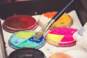 Cosmetics for face painting close up. Toned image with selective focus