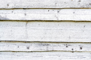 Dirty, old weathered white outside wooden plank wall