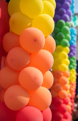 Fototapeta na wymiar Many rainbow colorful balloons vertical frame