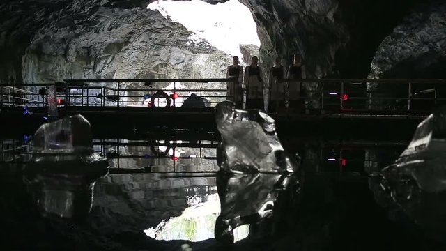 Four girls in traditional dresses on the panton way in the cave