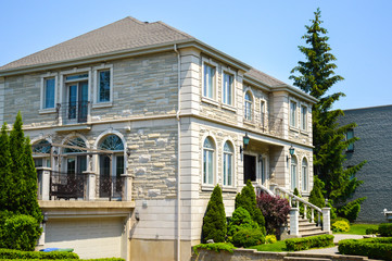 Fototapeta na wymiar Expensive modern large white house with huge windows in Montreal, Canada.
