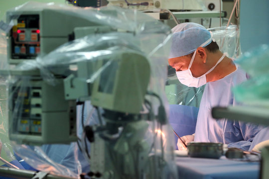 Surgeon performing cardiac surgery in the operating room