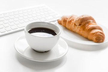 Business breakfast in office with coffee and croissant on white table background