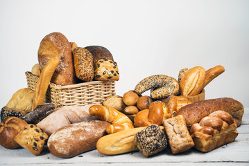 Assortment of baked bread on wooden rustic table background