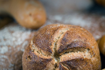 Assortment of baked bread on wooden rustic table background