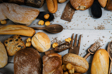 Assortment of baked bread on wooden rustic table background