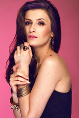 Portrait of sexy  woman with long brunette curly hair . Studio shot.