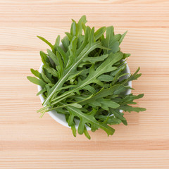 fresh wild rocket / White porcelain bowl with arugula