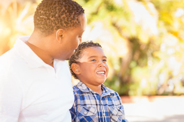 Mixed Race Son and African American Father Playing Outdoors Together.