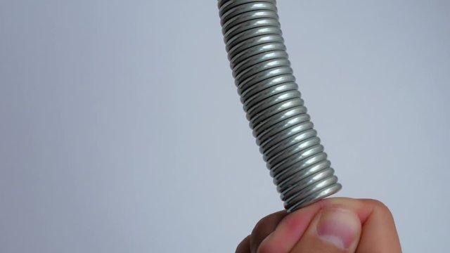 Man bends the spring with his hands