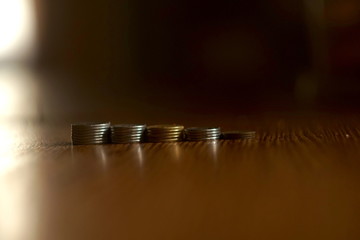 Close-up Of Coins Stack On Wooden Table, Focus