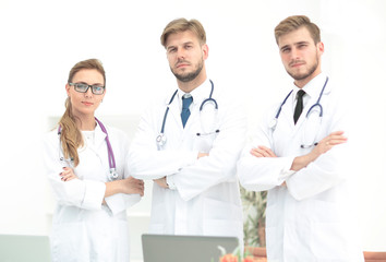 Team of medical professionals  looking at camera, smiling.