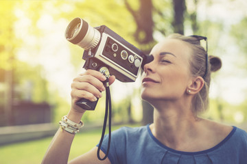 Summer. Young beautiful woman with vintage camera