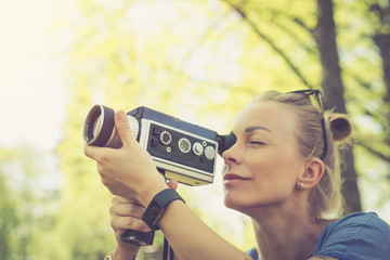 Summer. Young beautiful woman with vintage camera