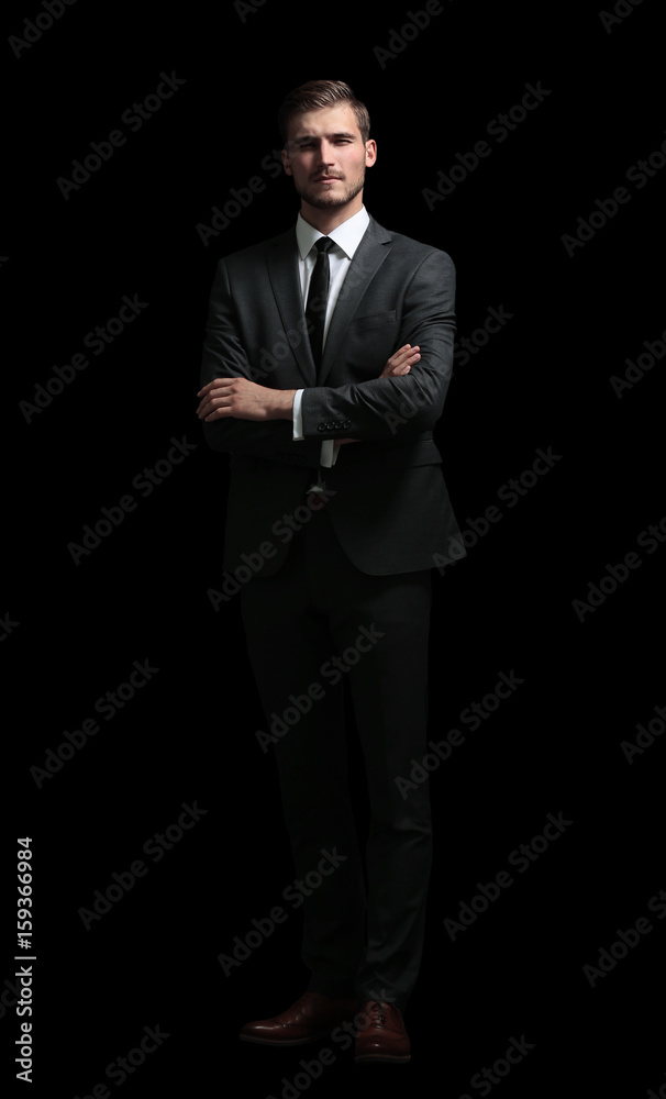 Sticker Handsome business man isolated on black with arms crossed