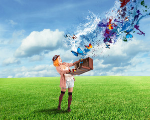 Clown opens a suitcase which emerges butterflies