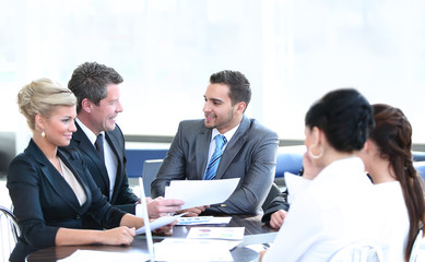 Business people working around table in modern office