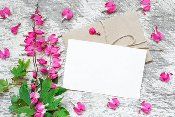 creative branding mock up to display your artworks. blank greeting card with pink flowers with heart shaped buds