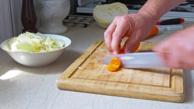 man chopping vegetables in the kitchen
