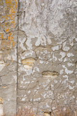 Grunge wall worn, rough masonry, cracks on the wall, plaster fell