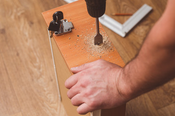 Drilling holes with a drill to install a mortise lock