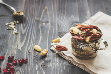 Nuts mix with seeds and dried fruits. Cashews, almonds and pecans on the wooden table