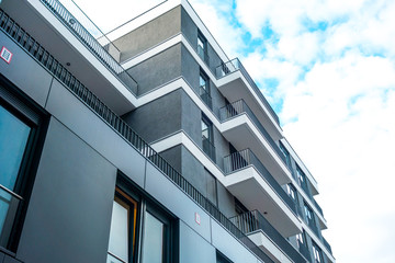grey building with white balconies