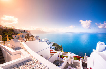 Oia town on Santorini island, Greece. Traditional and famous houses and churches with blue domes...