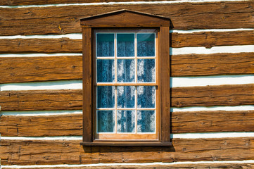Rustic timber wall with window and curtain