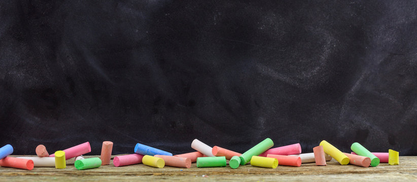 Colorful chalks and a blackboard