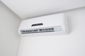White split air conditioner on a white wall. Home interior in a small apartment