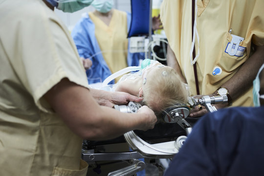 Doctors installing the cranial clamp to the patient's head