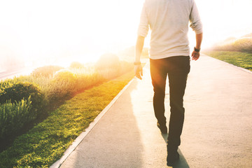 Low section of a man walking in the park