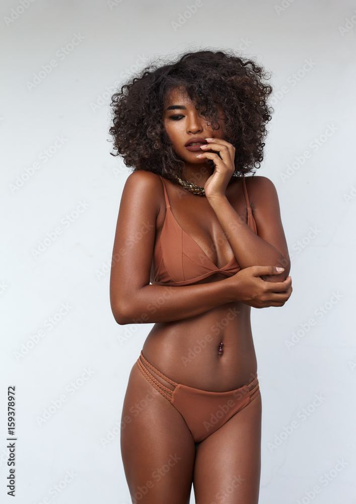 Wall mural Studio portrait ethnic dark skin female model in bikini