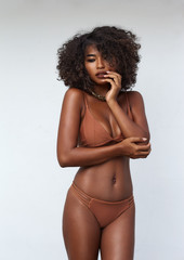 Studio portrait ethnic dark skin female model in bikini - obrazy, fototapety, plakaty