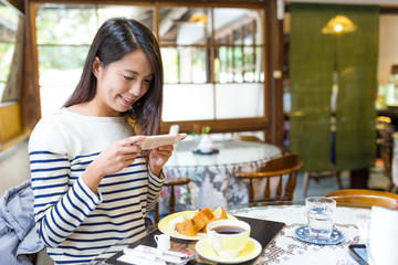 Woman taking photo on her breakfast