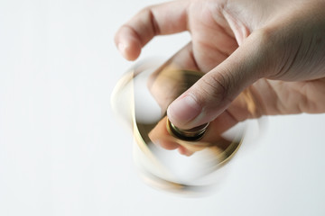 Goldren metal fidget spinner spinning on table