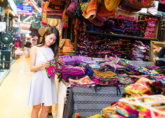 Fototapeta na wymiar Young Woman shopping in weekend market