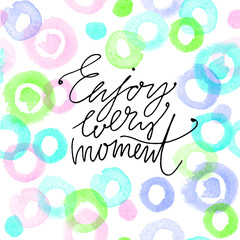 Hand drawn vector lettering. Enjoy every moment phrase by hand on bright background. Vector illustration. Handwritten modern calligraphy. Inscription for postcards, posters, prints, greeting cards.