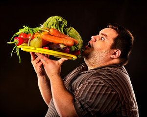 Diet fat man eating healthy food with vegetables for overweight male. Male trying to lose weight...