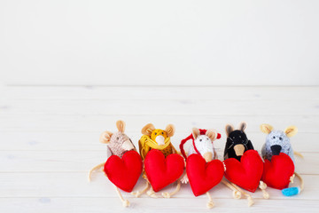 Homemade toy mouse. Mouse holding a heart.